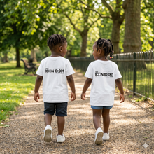 Load image into Gallery viewer, Two children walking on a path in a park wearing white t-shirts with text.
